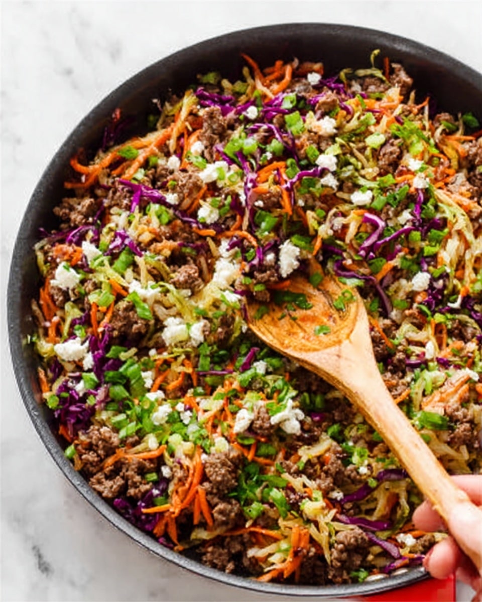 The image shows a close-up of a skillet filled with a colorful mix of cooked ingredients. The dish has several layers: at the bottom, cooked ground meat with a brown texture, mixed with shredded orange carrots and thin strips of purple cabbage, all evenly spread. On top, small white crumbles of cheese are scattered throughout the mixture. Bright green chopped herbs are sprinkled across the entire dish, adding fresh contrast. A woman's hand holds a wooden spoon stirring the ingredients gently. The skillet is on a white marbled surface. Photo taken with an iphone --ar 4:5 --v 7