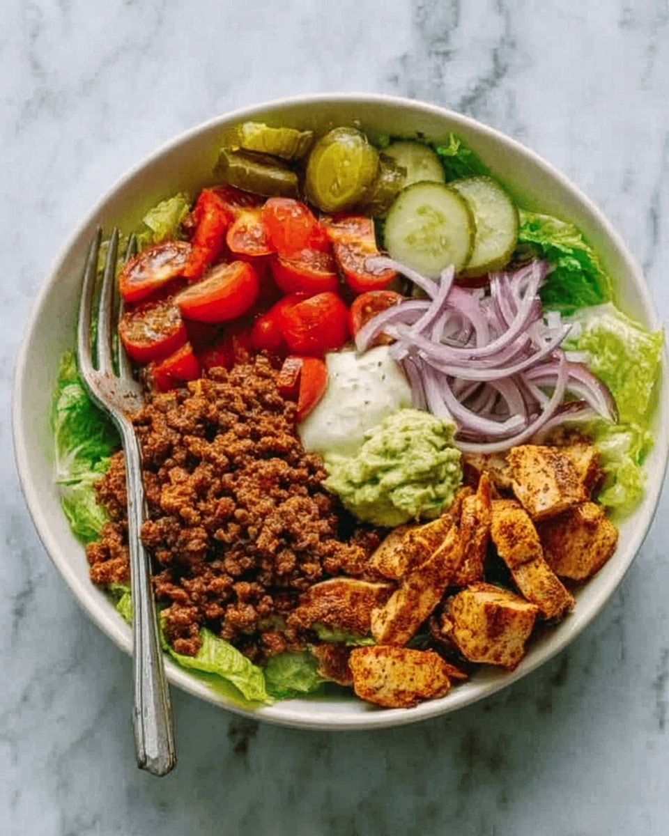 The image shows a white bowl filled with several different layers of food on a white marbled surface. At the base, there are fresh green lettuce leaves. On top, there is a layer of cooked ground meat with a brown color, next to cut red cherry tomatoes and thinly sliced red onion rings. There are also several slices of green pickles along with a scoop of creamy white sauce and a green dollop of guacamole. A few pieces of seasoned, cooked chicken with a golden-brown color sit on one side of the bowl. A silver fork is placed inside the bowl on the left side. photo taken with an iphone --ar 4:5 --v 7