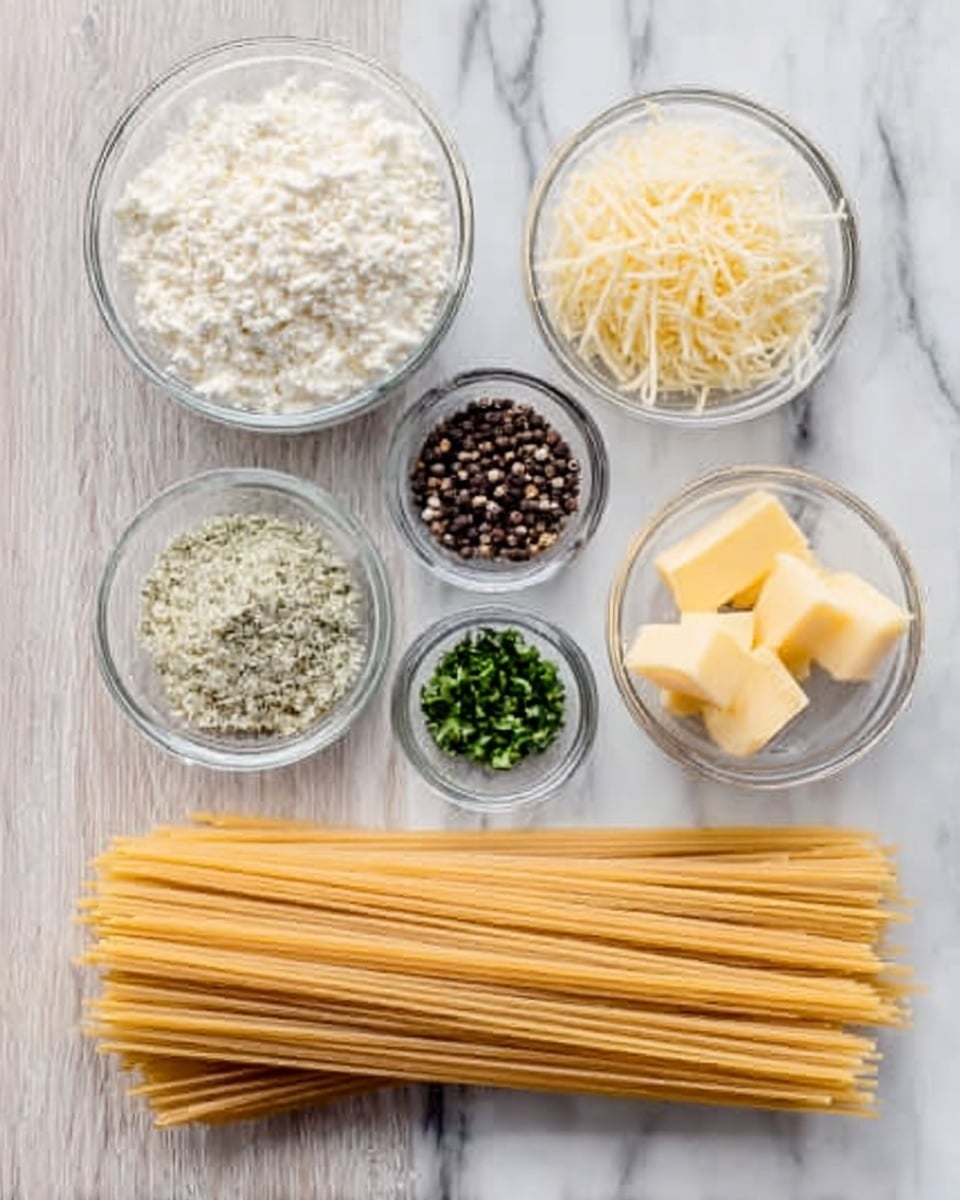The image shows five small clear glass bowls arranged in a loose semicircle above a bundle of long dry spaghetti on a light wooden surface. The bowls contain different ingredients: one bowl holds grainy white ricotta cheese, another has finely shredded pale yellow cheese, a third bowl contains small black peppercorns, the fourth has chopped green herbs, and the last one holds four small rectangular pieces of yellow butter. Below the bowls, the straight spaghetti sticks are lined up horizontally, showing their light golden color and smooth texture. The background is a white marbled surface. Photo taken with an iphone --ar 4:5 --v 7