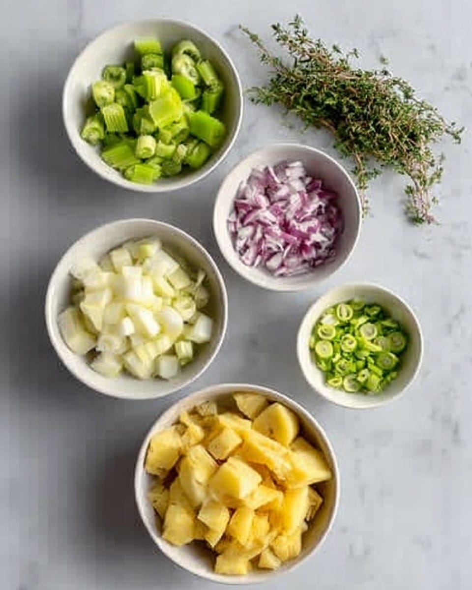 The image shows five white bowls placed on a white marbled surface, each filled with different chopped ingredients. One bowl contains green celery pieces, another has pale slices of peeled white root vegetables, a third holds small chopped red onions, a fourth bowl is filled with thin green slices of scallions, and the largest bowl contains medium-sized yellow potato chunks. A small bunch of fresh green herbs lies near the top of the bowls. The photo was taken with an iphone --ar 4:5 --v 7