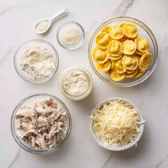 The image shows five groups of ingredients on a white marbled surface. On the top right, there is a clear glass bowl full of yellow round ravioli stacked loosely. Below it to the left, a clear glass bowl holds shredded light brown chicken pieces. To the right of the chicken, another clear glass bowl contains white shredded cheese. Above the cheese, a small glass jar is open, showing creamy white sauce inside. To the top left of the jar, there is a small white spoon with a light beige powder. Below the spoon, a small white bowl contains finely grated light yellow cheese. Photo taken with an iphone --ar 4:5 --v 7