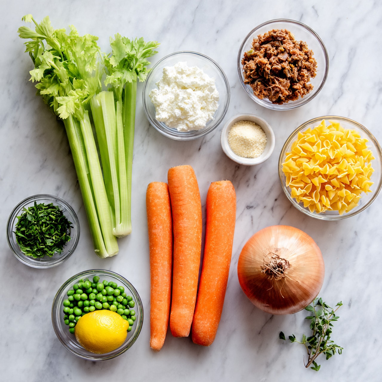 The image shows a white marbled surface with various ingredient bowls and vegetables arranged neatly. There are three whole, smooth orange carrots placed horizontally in the center. To the left, three stalks of fresh celery stand upright. In small clear bowls, there are green peas, a brownish mixture that looks like shredded meat, white creamy sauce, a small amount of powder, and yellow pasta pieces. A whole red onion and a lemon are also placed on the surface, along with a small sprig of green herb near the bottom. Everything is organized neatly, bright, and clear. Photo taken with an iphone --ar 4:5 --v 7