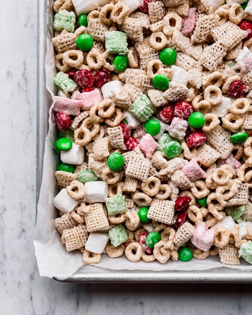 The image shows a close-up of a white rectangular tray filled with a mix of cereal pieces. The cereal includes light beige O-shaped pieces, small round colorful candy-coated pieces in green and red, and crunchy puffed marshmallow shapes in pink, white, and green. The tray is lined with white parchment paper, and the background is a white marbled texture. The textures appear crunchy and varied, with a colorful and bright look overall. photo taken with an iphone --ar 4:5 --v 7