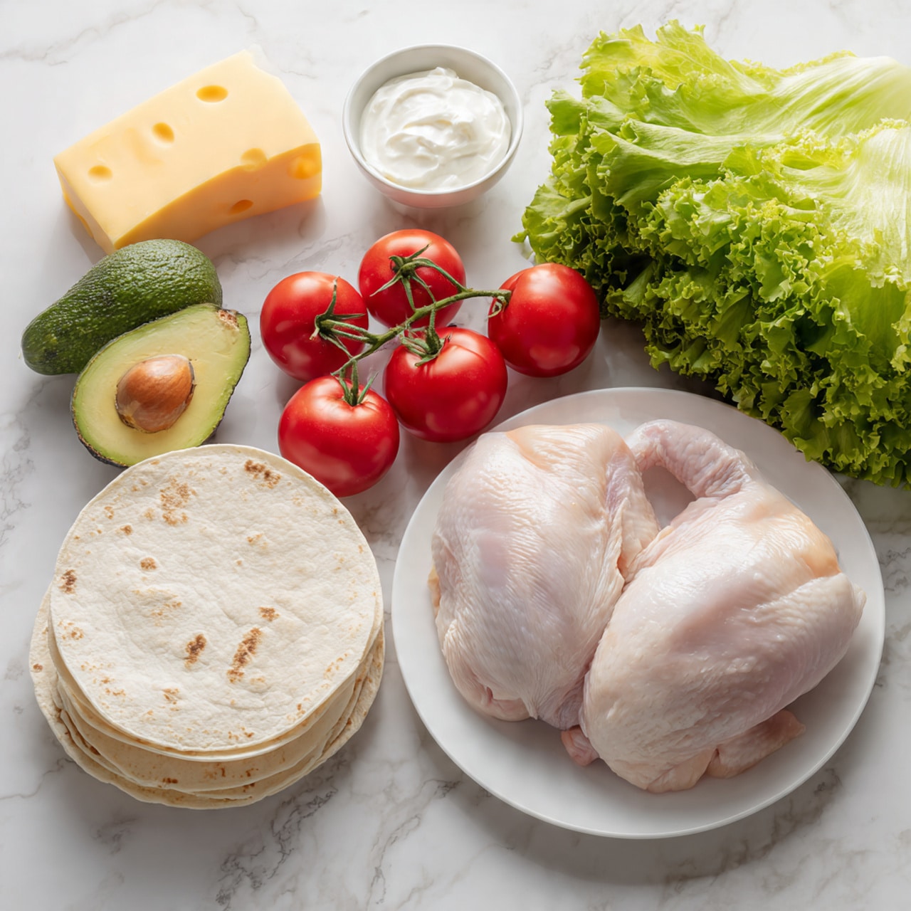 The image shows a white plate with two raw chicken pieces placed side by side on the lower right. To the left of the plate, there is a small stack of round white tortillas on a white marbled surface. Above the tortillas are three red tomatoes still on the vine, and next to them are two halves of a green avocado with the seed visible in one half. Behind the tomatoes and avocado, there is a bunch of fresh green leafy lettuce. In the upper left corner, there is a block of yellow cheese and a small white bowl filled with white cream or sour cream. The whole scene is placed on a white marbled surface. Photo taken with an iphone --ar 4:5 --v 7