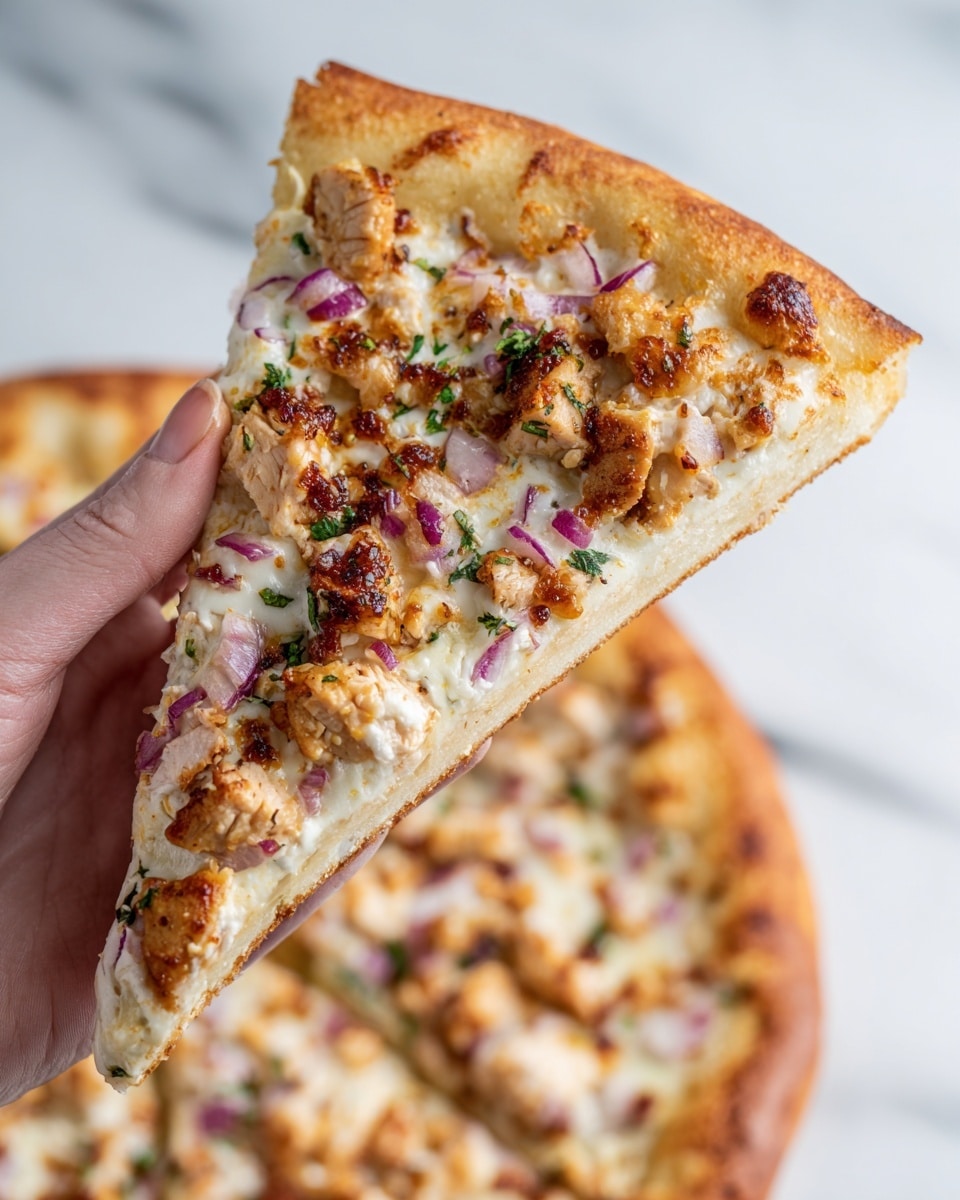 The image shows a close-up of a pizza slice held by a woman's hand, revealing three main layers: a thick, golden-brown crust at the bottom with a slightly crispy texture; a middle layer of melted white cheese that is creamy and stretches slightly; and the top layer covered with small, browned chunks of cooked chicken, thin purple onion slices, and small green herb pieces scattered across. The pizza looks fresh and rich in color, all set against a white marbled surface. Photo taken with an iphone --ar 4:5 --v 7