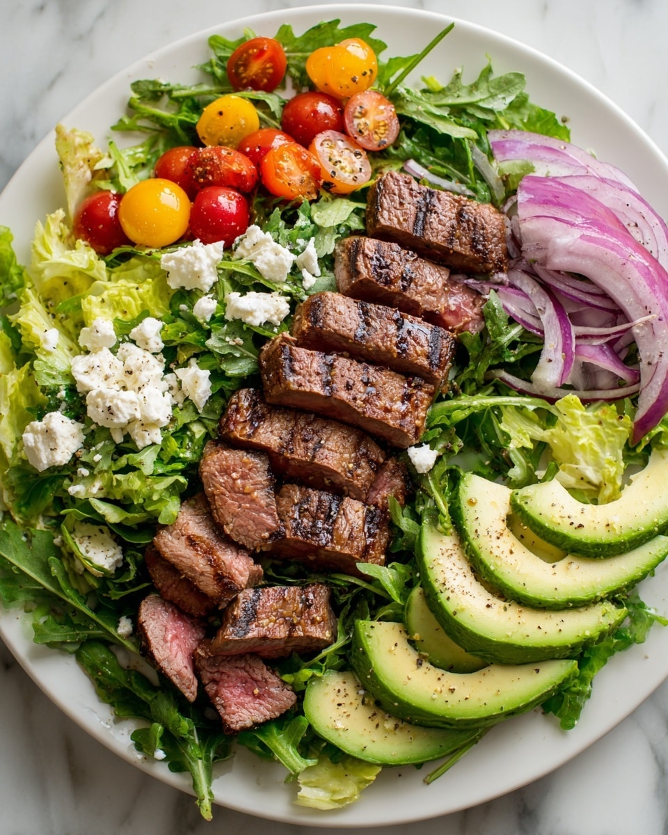A white plate holds a fresh salad with layers starting from a base of green arugula and light yellow lettuce leaves scattered evenly across. On top, there are six groups of sliced grilled steak pieces showing a brown outer grill mark and pinkish inside, placed evenly around the plate. Bright yellow and red cherry tomato halves add pops of color, tucked between the greens. Thin slices of red onion curls lie spread around the salad. Two rows of sliced avocado halves with smooth creamy texture and sprinkled with black pepper are positioned opposite each other. Small white crumbles of cheese are scattered on the salad, providing contrast. The plate is arranged on a white marbled surface. Photo taken with an iphone --ar 4:5 --v 7