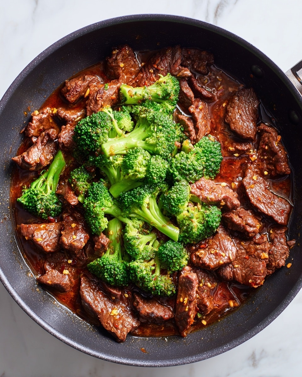 The dish shows several layers starting with thin slices of red raw beef spread out in a black pan, then browned beef pieces filling the pan. An orange-brown sauce with visible spices is poured over the browned beef, creating a shiny coating in the pan. Later, the beef is seen simmering in the sauce with some liquid visible around the pieces. Bright green broccoli florets are added on top of the beef and sauce, piled in the center of the pan. Finally, the broccoli and beef mix together, the broccoli still bright green and the beef dark and glossy from the sauce, all inside the black pan with a slightly shiny surface, on a white marbled background photo taken with an iphone --ar 4:5 --v 7
