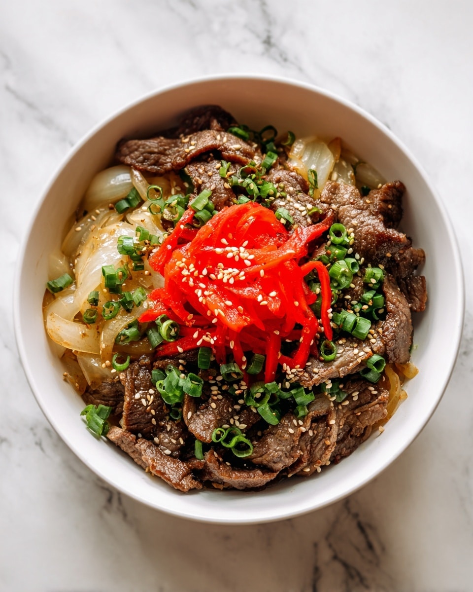 A white bowl filled with tender thin brown beef slices layered with translucent cooked onion strips, topped with a bright red pile of thin pickled ginger strips at the center. Scattered around are small rings of fresh green chopped scallions and a light sprinkle of tan sesame seeds, all resting on a white marbled surface. photo taken with an iphone --ar 4:5 --v 7