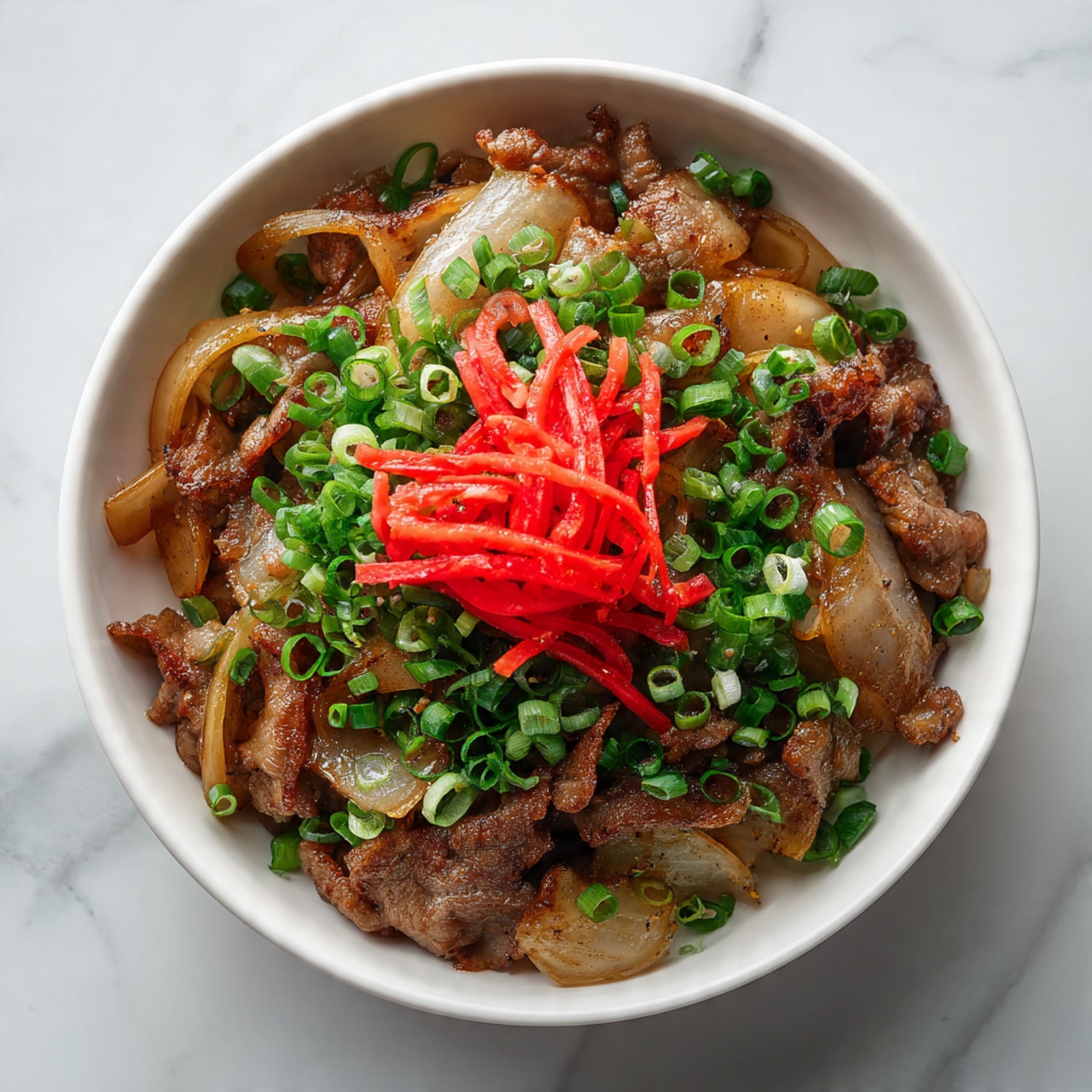 The dish is shown in a white bowl with three main layers. The bottom layer is slices of cooked beef with a brown color and a soft, slightly glossy texture. Mixed within the beef are cooked onion slices that are light brown and translucent. The middle layer has chopped green onions sprinkled evenly around, adding small bright green rings throughout. The top layer is a small pile of thin, twisted red pickled ginger strips in the center, creating a bright contrast to the rest of the dish. The bowl is set on a white marbled texture surface. photo taken with an iphone --ar 4:5 --v 7