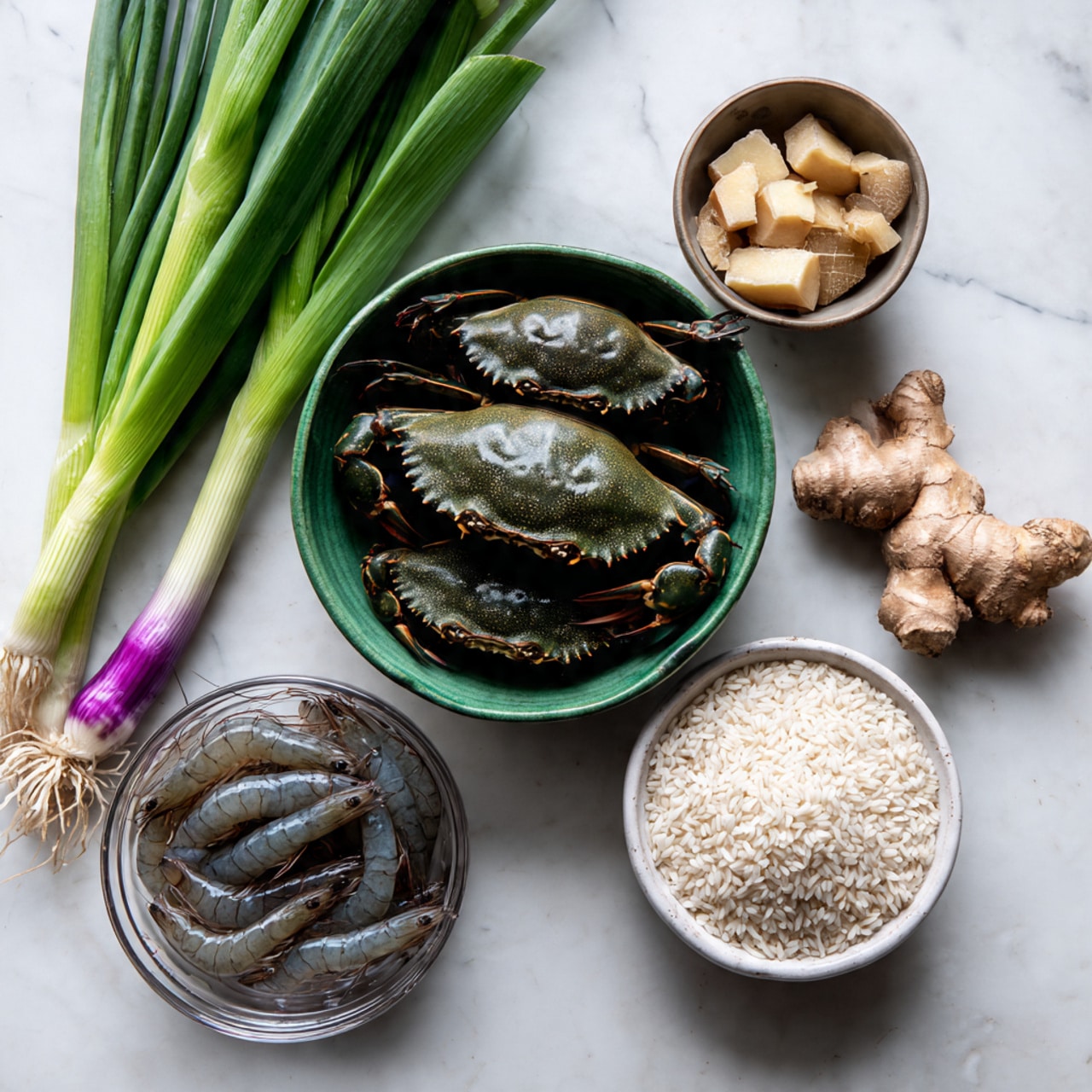 The image shows a green bowl on a white marbled surface filled with two dark green crabs tied with purple string. Next to the bowl is a clear glass bowl with small beige chunks and a piece of ginger root. Below these bowls, there is a small white bowl filled with white rice grains. To the left side of the image, there are fresh green onions with white and purple roots laying on the surface, partially resting on a sealed plastic bag filled with dark gray shrimps inside. photo taken with an iphone --ar 4:5 --v 7