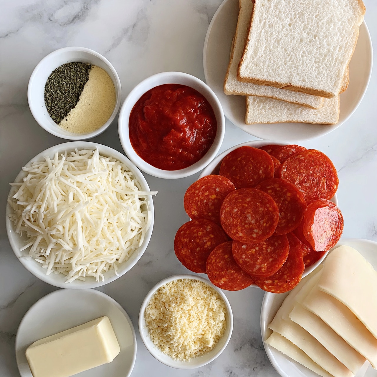 square image The image shows six white bowls and one white plate arranged on a white marbled surface. The white plate at the top right holds four slices of white bread stacked slightly overlapping. Below the bread is a white bowl filled with round slices of pepperoni, bright red with specks of fat. To the left of the pepperoni bowl is a white bowl filled with shredded white cheese, with long thin strands. Above the shredded cheese bowl is a small white bowl with a mix of dried green herbs and pale yellow powder, split in halves. To the right of this bowl is a white bowl filled with thick, red tomato sauce with a smooth texture. Below and to the right of the pepperoni is a small white bowl filled with finely grated pale yellow cheese. At the bottom left is a small white plate with a rectangular stick of pale yellow butter. At the bottom right is a white plate with several slices of pale sliced cheese neatly stacked. Photo taken with an iphone --ar 4:5 --v 7