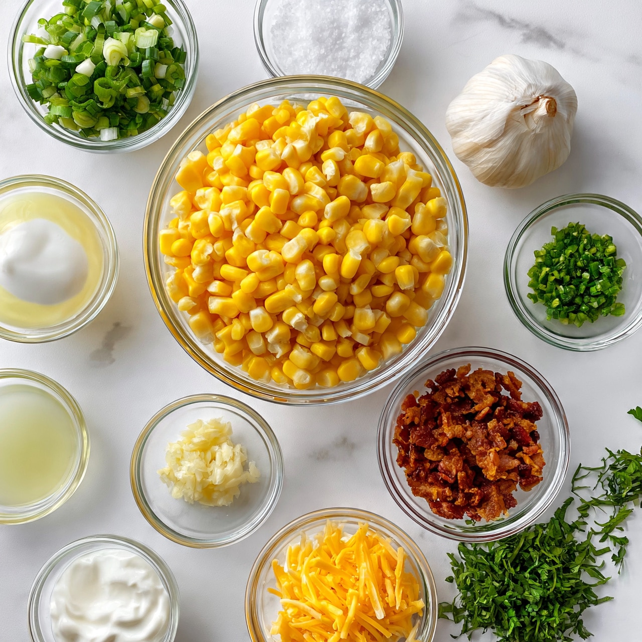 square image A top view of multiple clear glass bowls with separate ingredients arranged neatly on a white marbled surface, consisting of a large bowl of bright yellow corn kernels in the center, above it a bowl with chopped green onions and a small bowl with coarse salt, to the right a bulb of garlic and a small bowl of finely chopped green chili, below the corn a bowl with crispy brown bacon pieces, to the bottom right fresh green herbs, bottom center a bowl of shredded yellow cheese, and scattered around are small bowls of white sour cream, minced garlic, and two bowls with pale yellow and white liquids, all displayed in an organized manner photo taken with an iphone --ar 4:5 --v 7