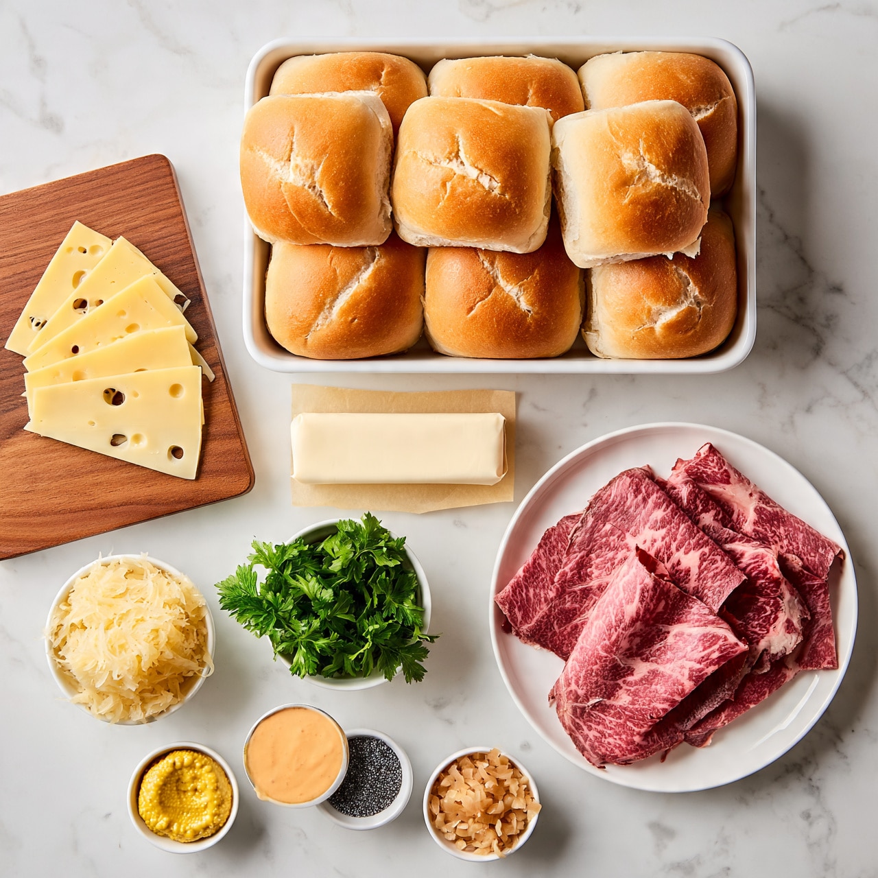 Baked Reuben Sliders Recipe 4 square imag The image shows ingredients laid out on a white marbled surface including a white round plate with several thin slices of marbled pink roast beef on the right side. Above it is a white rectangular tray holding 12 soft, golden brown sandwich rolls with light cracks on the top. To the left of the tray is a wooden board holding five thin slices of Swiss cheese with holes. In the middle is a stick of unsalted butter wrapped in cream-colored paper. Below the butter are small white bowls: one with sauerkraut that looks shredded and pale yellow, one with bright green fresh parsley leaves, one with yellow mustard, one with a light orange sauce, one with small black poppy seeds, and one with finely chopped light tan onions. The arrangement is neat and clean, placed on the white marbled surface. photo taken with an iphone --ar 4:5 --v 7