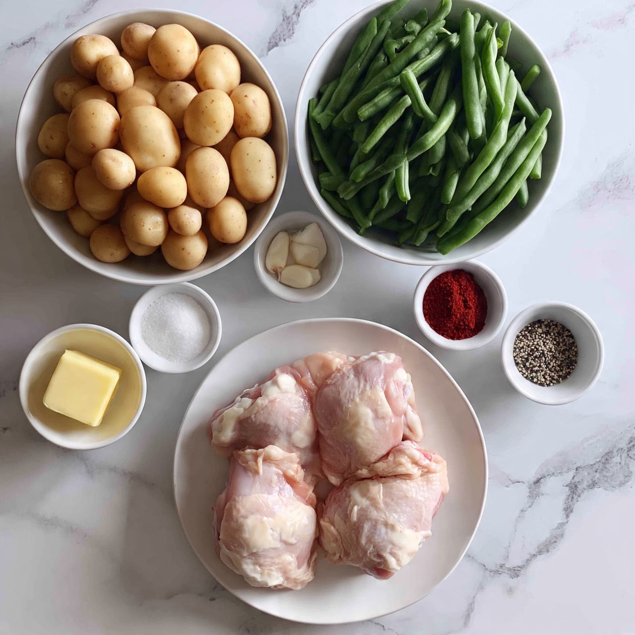 square image The image shows a white plate at the bottom center with four pieces of raw chicken thighs, pale pink with some white fat. To the top left, there is a large white bowl filled with many small round light brown potatoes. Above the plate, there is a large white bowl filled with fresh green beans, long and smooth. Around the bowls and plate, there are smaller white bowls: one with a small block of yellow butter, one with white powdery salt, one with red spice powder, one with a mix of black and white coarse pepper, and one with three garlic cloves placed in a small white bowl. All items are set on a white marbled surface that fills the background. photo taken with an iphone --ar 4:5 --v 7