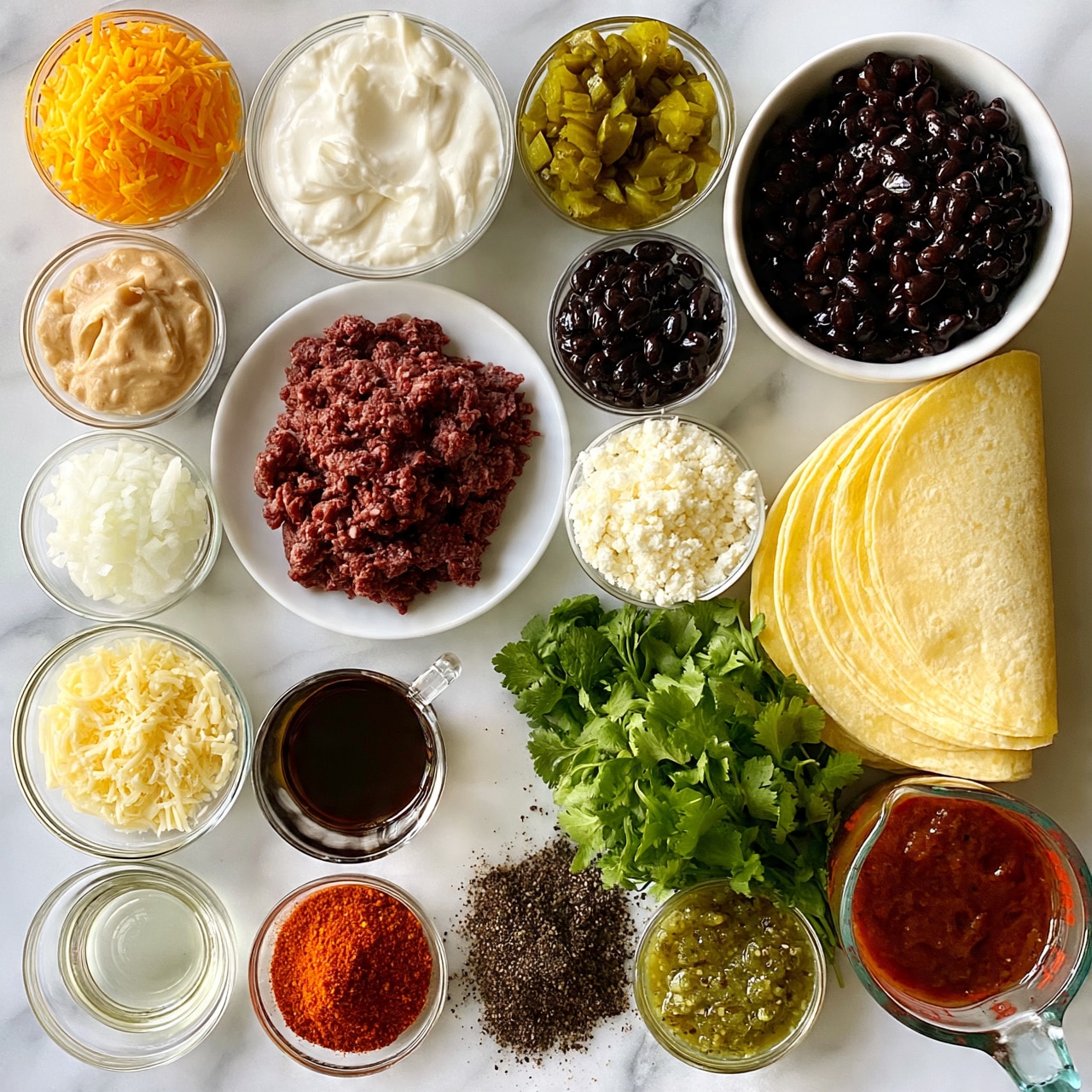 square image The image shows an overhead view of many small glass bowls and a white plate arranged neatly on a white marbled surface. There are vibrant orange shredded cheese, white sour cream with a smooth texture, dark red raw ground meat on a white plate, chopped green pickles, shiny black beans, finely chopped white onions, light brown creamy sauce, pale shredded cheese, white crumbly cheese, a clear glass cup with a dark brown sauce, soft yellow tortillas stacked, a bunch of fresh green cilantro, clear oil in a small bowl, bright red spice powder, dark pepper powder, a bowl of green salsa, and a measuring cup filled with thick red sauce. Everything is cleanly placed and color contrasts strongly. photo taken with an iphone --ar 4:5 --v 7