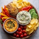 Colorful Hummus Veggie Board with Pita, Crackers, and Olives Recipe