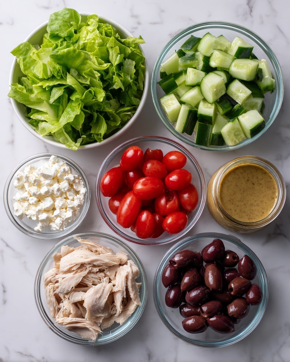 The image shows six small white bowls arranged on a white marbled surface. The top bowl contains fresh green leafy lettuce with a soft texture. Below it to the left is a bowl filled with light and dark green cucumber pieces, which are cut into chunks showing a moist texture. To the right is a bowl with halved bright red cherry tomatoes, glistening and juicy. Below these, on the left, is a bowl holding slices of light beige cooked chicken with a slightly rough texture. To the right is a jar of mustard-colored dressing with a slightly grainy look. Next to it, lower on the surface, is a bowl of dark purple olives that appear shiny and firm. At the bottom left corner, there is a bowl filled with crumbly white cheese. All bowls are clear glass, showing the vivid colors of the food inside. The photo is taken with an iphone --ar 4:5 --v 7