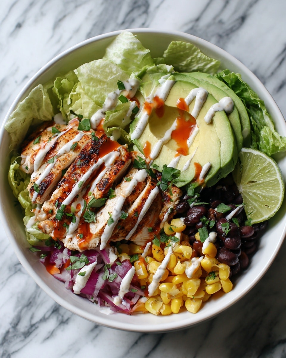 A white bowl filled with a colorful layered dish sits on a white marbled surface. The bottom layer has mixed black beans, corn, and red onions, showing vibrant yellow, black, and purple colors. On top of this is a bed of light green lettuce leaves. The next layer has strips of cooked white chicken covered with a drizzle of creamy white sauce and a reddish-orange sauce. On top of this, several slices of bright green avocado are laid next to a wedge of lime. The dish is finished with a sprinkle of fresh green herbs. Photo taken with an iphone --ar 4:5 --v 7