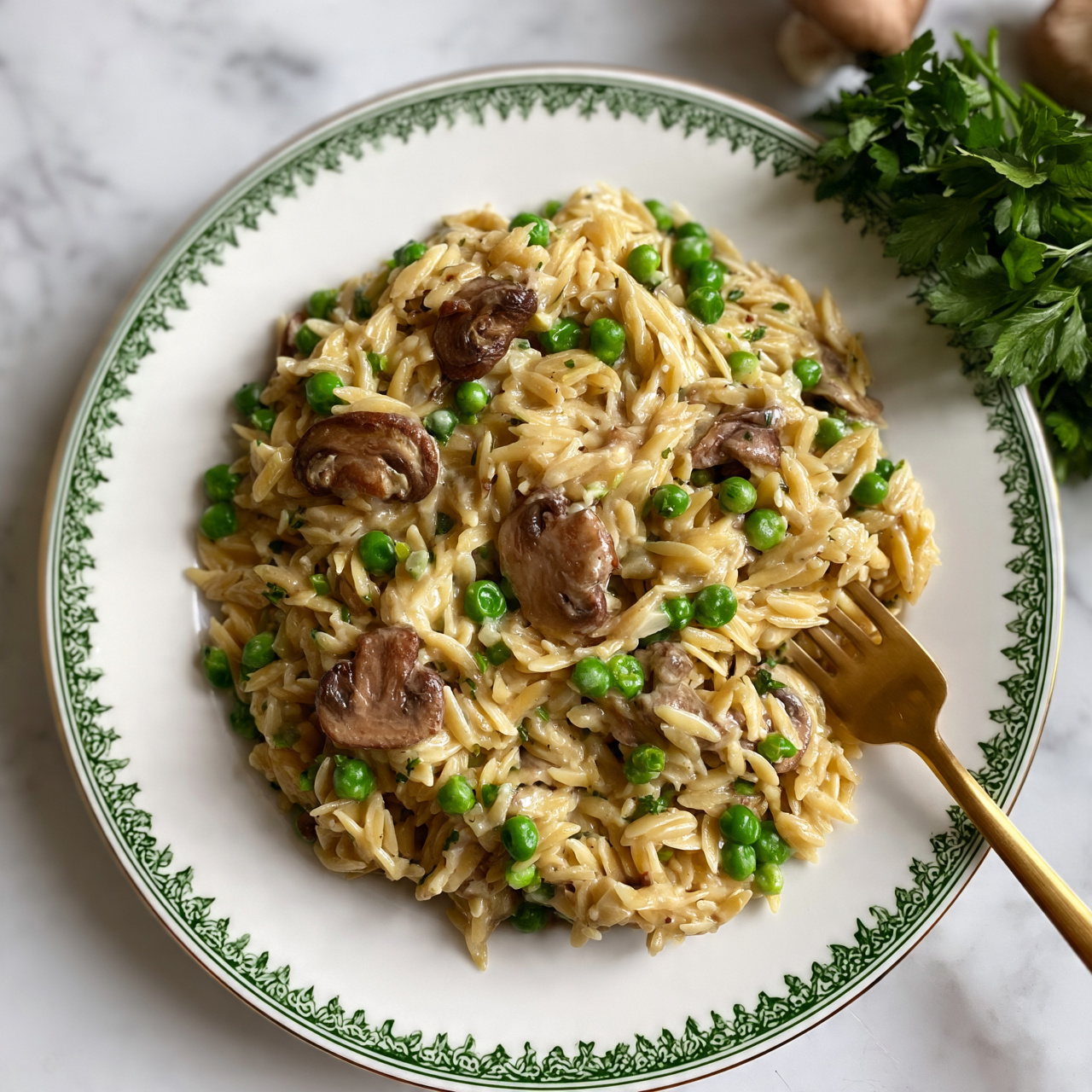 square image A white plate with a green decorative rim holds a dish of orzo pasta mixed with sliced brown mushrooms and bright green peas. The orzo is light golden with a creamy texture, evenly mixed with small green peas and tender pieces of mushroom scattered throughout. A golden fork rests in the orzo near the bottom right of the plate, partially lifted as if ready to take a bite. The plate is placed on a white marbled surface, near a bunch of fresh green parsley and some whole mushrooms in the top right corner. The lighting is soft and natural, highlighting the fresh ingredients and creamy texture of the dish. photo taken with an iphone --ar 4:5 --v 7