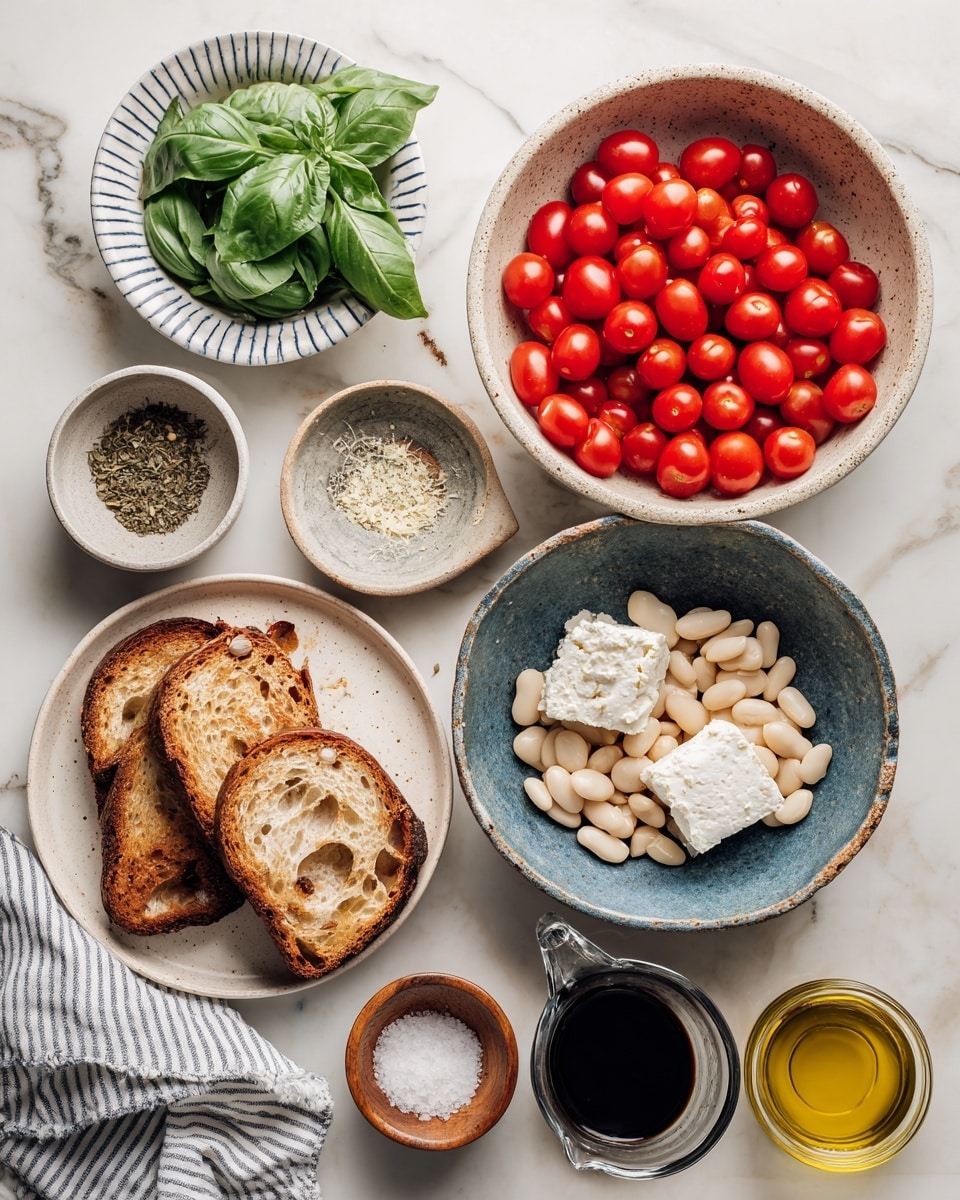 A flat lay of ingredients on a white marbled surface includes six main groups: a large white bowl on the top right filled with bright red cherry tomatoes, a smaller speckled beige bowl on the bottom right holding three chunks of crumbly white cheese, a rustic blue-grey bowl in the center filled with plump white beans, a white plate on the bottom left with four pieces of toasted brown bread, a small white striped bowl above the bread containing fresh green basil leaves, and three smaller bowls at the top center with dried herbs in a dark blue bowl, minced garlic in a white bowl with a blue rim, and salt in a small wooden bowl. Near the bottom right corner, a clear glass measuring cup with dark balsamic vinegar and a round clear bowl with golden olive oil are visible. A striped towel peeks out from the bottom left corner. photo taken with an iphone --ar 4:5 --v 7
