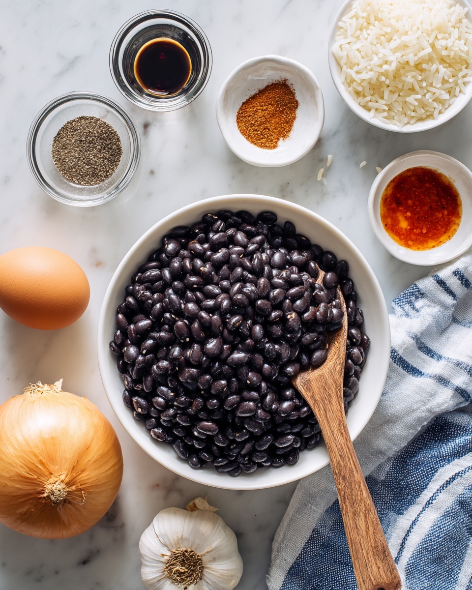 A white bowl filled with shiny black beans with a wooden spoon resting inside it sits on a white marbled surface. Nearby are small white bowls containing a swirl of ground black pepper, a heap of brown spice, and light-colored rice. There are also two small clear glass bowls, one holding a dark liquid and the other a red sauce, all on the white marbled surface. A whole yellow onion, garlic bulb, and a brown egg are placed in the lower part of the image beside a white bowl with rice and a blue and white striped cloth. Photo taken with an iphone --ar 4:5 --v 7
