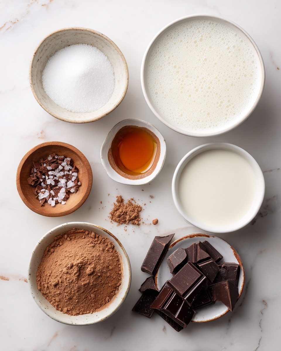 The image shows seven small containers arranged on a white marbled surface, each with different ingredients. At the top right, there is a large white bowl filled with a foamy white liquid. Near it to the left is a small white bowl filled with granulated sugar. Below the sugar bowl, a small white dish with a brown rim holds a small amount of amber-colored vanilla extract. To the right of the vanilla extract is another white bowl with a smooth white liquid inside. Next to that is a white bowl filled with light brown cocoa powder. At the bottom right, a white bowl holds broken pieces of dark chocolate, with some pieces scattered on the surface beside it. At the bottom left, there is a small wooden bowl with coarse salt. The photo is taken with an iphone --ar 4:5 --v 7
