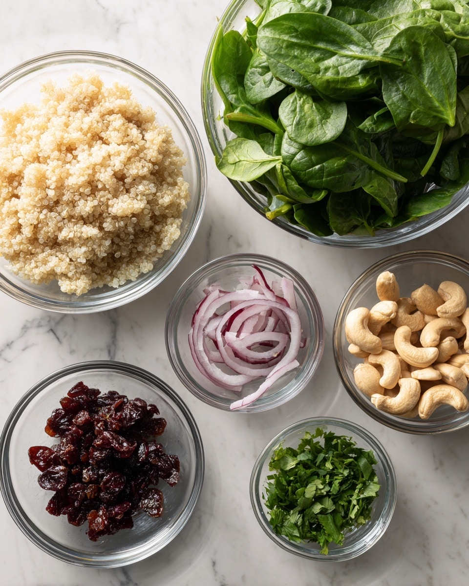 The image shows six clear glass bowls of different sizes arranged on a white marbled surface. In the largest bowl at the bottom left, there is light beige cooked quinoa with a fluffy texture. Above it, a slightly smaller bowl holds fresh green spinach leaves that look crisp and vibrant. To the right of the spinach, a medium bowl contains thinly sliced red onion pieces that are shiny and a bit curled. Below the onion, there is a small bowl with chopped dark red dried cranberries. Next to it on the right is an even smaller bowl with pale, smooth cashew nuts. At the bottom right, a small bowl holds fresh chopped green herbs, likely cilantro or parsley. The bowls are neatly spaced, showing all the ingredients clearly. photo taken with an iphone --ar 4:5 --v 7