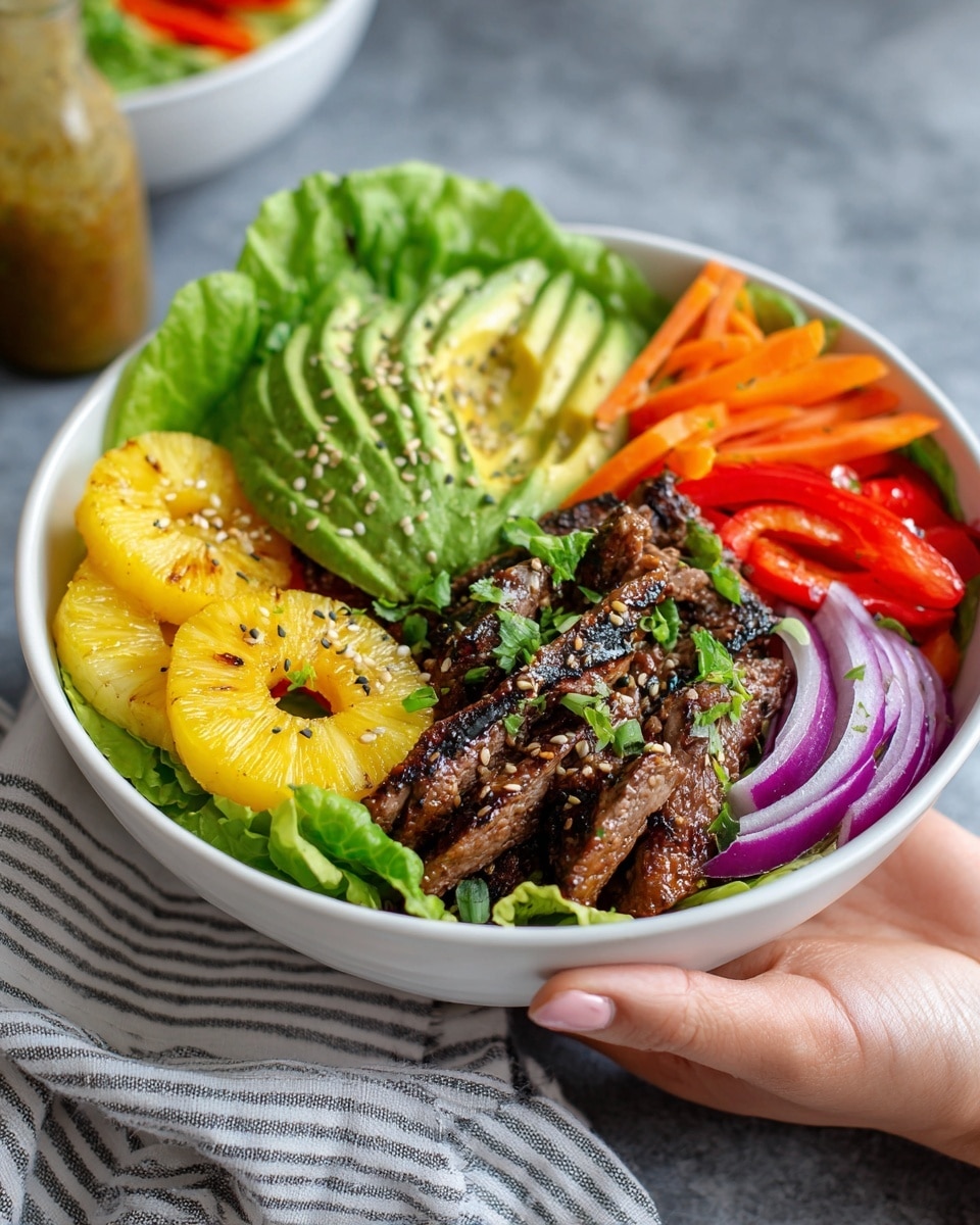 A white bowl filled with fresh green lettuce as the base layer, topped with slices of grilled pineapple rings on one side, bright green avocado slices next to it, and dark brown grilled meat strips placed near the avocado, sprinkled with sesame seeds and small green herb leaves. On the opposite side, there are thin orange carrot strips, red bell pepper pieces, and thinly sliced purple onion rings spread around the edges. The bowl sits on a grey surface with a sauce bottle and another similar bowl blurred in the background. A woman's hand holding the bowl's edge with a striped cloth under it. photo taken with an iphone --ar 4:5 --v 7