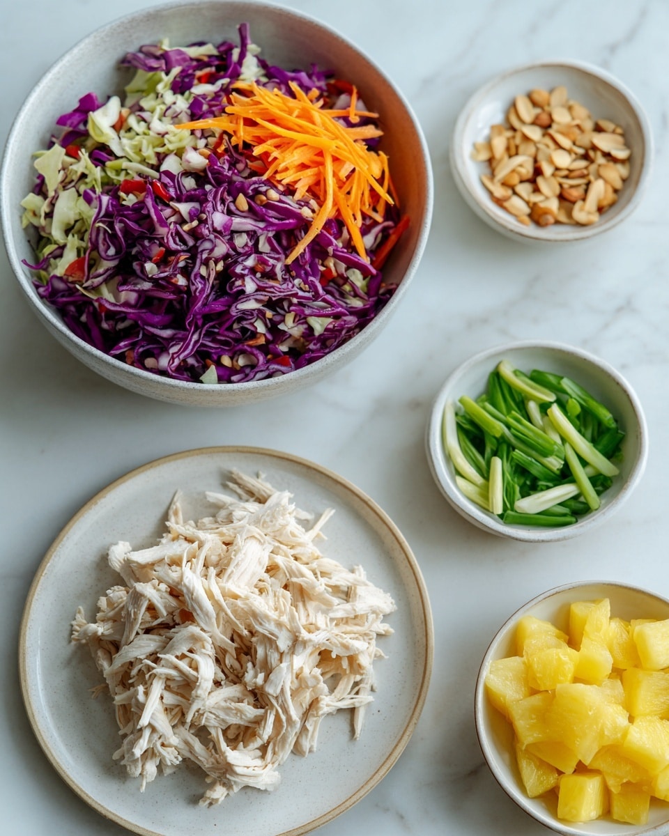 The image shows a collection of white dishes on a white marbled surface. In the largest bowl, there is a colorful mix of shredded purple and green cabbage with thin orange carrot strips on top. Next to it, a plate is filled with white shredded cooked chicken, piled in a loose mound. There are three smaller white bowls around: one contains light brown sliced almonds, another has long thin green slices of scallions, and the third is filled with small yellow pineapple chunks. The overall layout is neat and inviting. Photo taken with an iphone --ar 4:5 --v 7