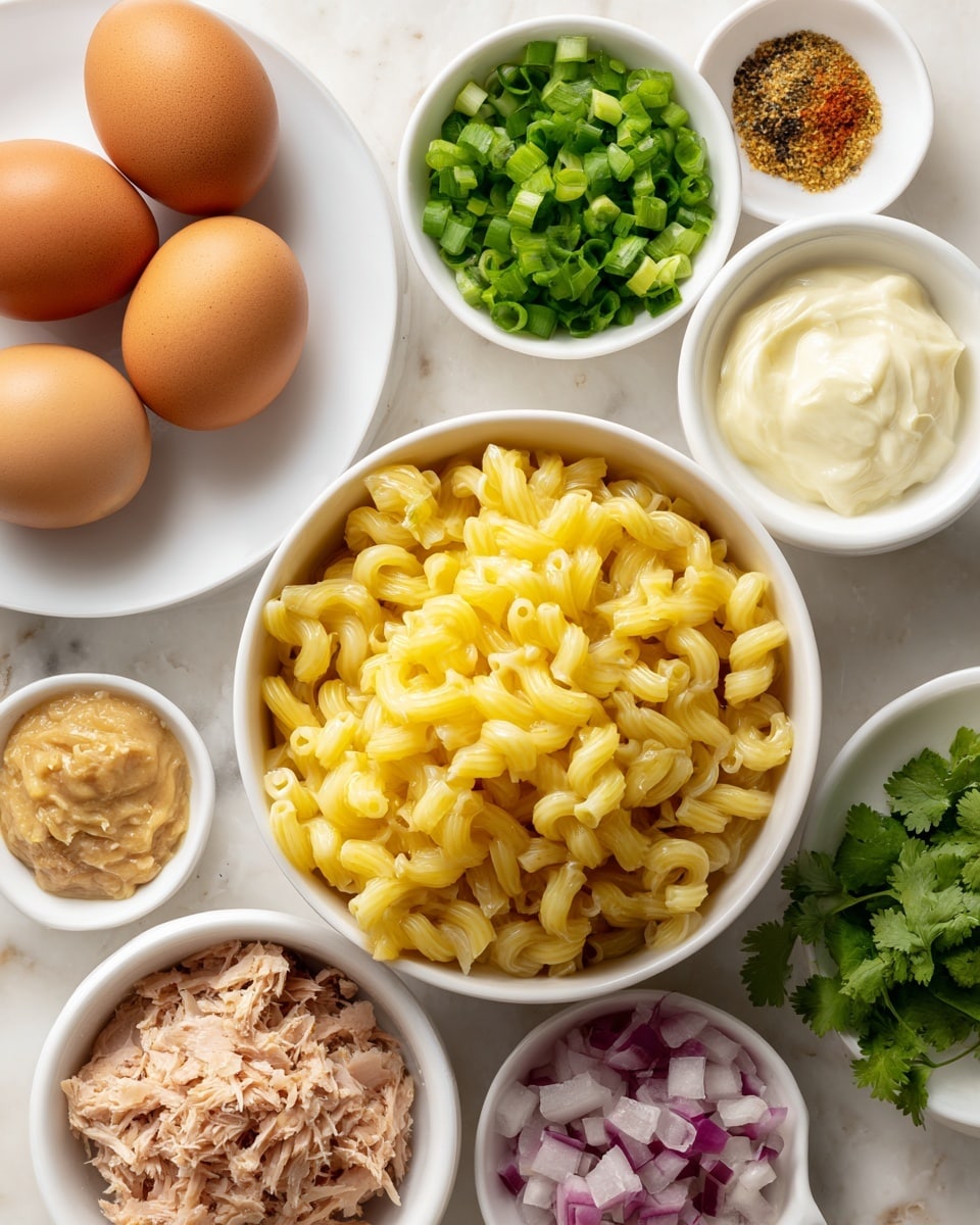 The image shows several small white bowls and plates on a white marbled surface, each holding different ingredients for a recipe. The largest bowl at the bottom right contains cooked elbow macaroni pasta, yellow in color with a slightly shiny texture. To its left, a smaller bowl holds chopped green onions, bright green and fresh-looking. Above this, another bowl contains light brown tuna flakes with a soft, flaky texture. At the top left, a white plate holds two whole brown eggs with smooth shells. Nearby, small white bowls contain finely diced red onions, creamy mayo with a smooth swirled surface, beige mustard paste with a grainy texture, fresh green cilantro leaves, and a pinch of black pepper. The overall layout is neat and the colors include yellow, green, red, brown, and white, all displayed against the clean white marbled background. Photo taken with an iphone --ar 4:5 --v 7