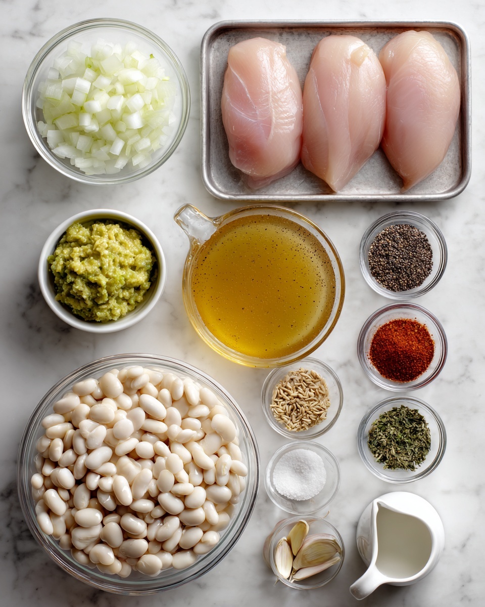The image shows a flat lay of cooking ingredients arranged neatly on a white marbled surface. In the center bottom is a clear glass bowl filled with cooked white beans, and next to it on the left is a small white bowl with diced white onions. Above the onions, there is a small white bowl with a greenish-yellow mix of mashed avocado or herbs. To the right of the beans is a clear glass measuring cup filled with golden brown broth. Near the top center, a metal tray holds two raw pink chicken breasts. Surrounding the tray are small clear glass bowls filled with various spices: black pepper, red powder (likely paprika), white salt, brown seeds, sliced garlic, and dried herbs. There is also a small white pitcher, possibly with cream, on the bottom right. The ingredients are arranged in a grid pattern with clear visibility of each texture and color, all on the white marbled surface. photo taken with an iphone --ar 4:5 --v 7