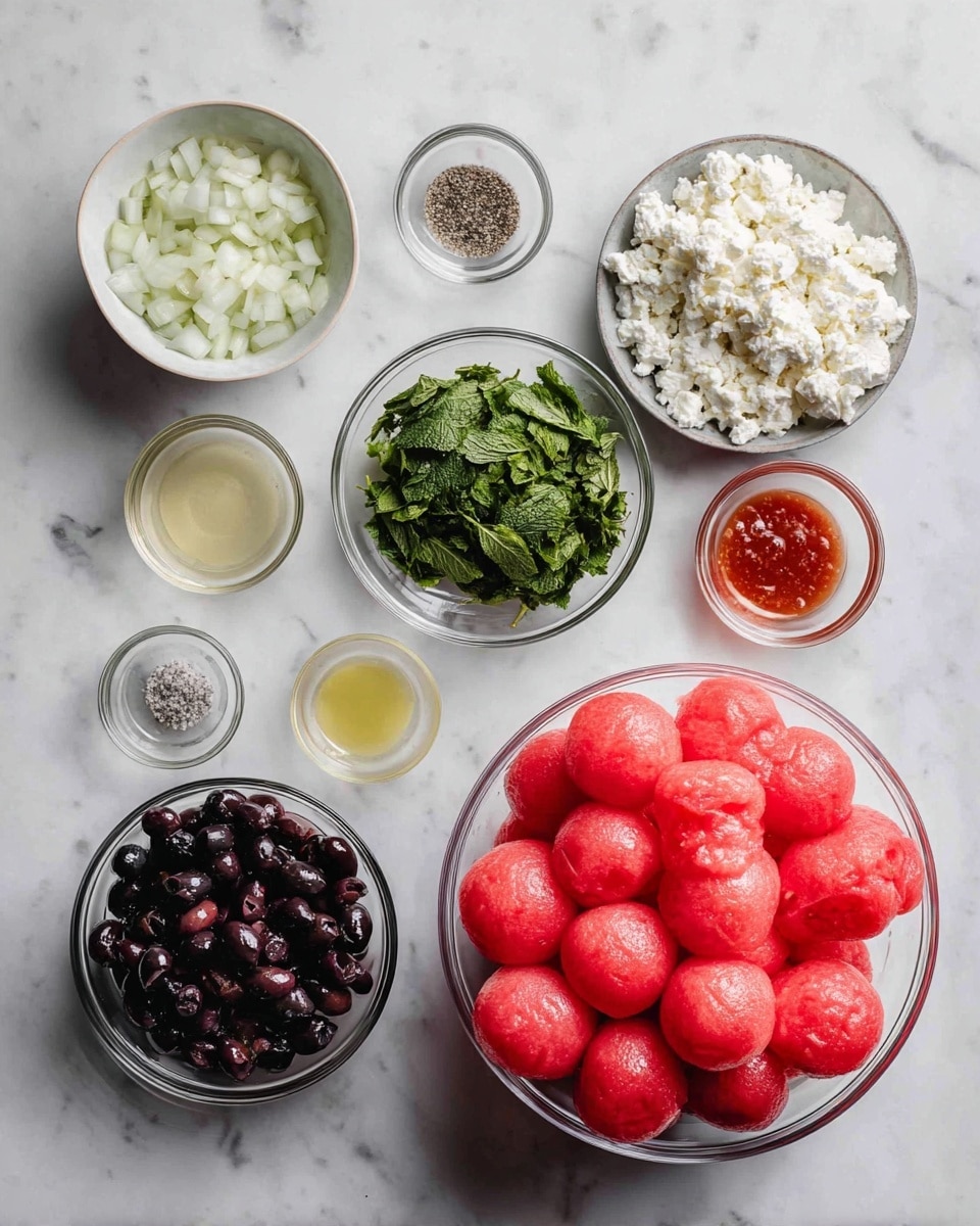 The image shows a top-down view of several bowls with fresh ingredients arranged neatly on a white marbled surface. On the right, a large transparent bowl is filled with red watermelon balls, smooth and round, stacked high. Moving left, there is a small white bowl with chopped white onions, next to a small white bowl full of fresh, green mint leaves roughly torn. Above these is a tiny clear bowl holding a reddish-brown sauce. Next to it are two smaller clear bowls containing coarse salt and black pepper. Above them, two small white bowls hold light-colored liquids, likely oil and vinegar. On the left, a medium clear bowl is filled with dark purple chopped olives. Below that is a white bowl filled with crumbly, white feta cheese, creating a contrast with the darker olives above. All the bowls are placed neatly and evenly spaced, balancing colors and textures well. Photo taken with an iphone --ar 4:5 --v 7