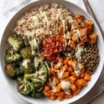 Colorful Vegan Buddha Bowl with Roasted Vegetables, Chickpeas, Quinoa, and Tahini Dressing Recipe