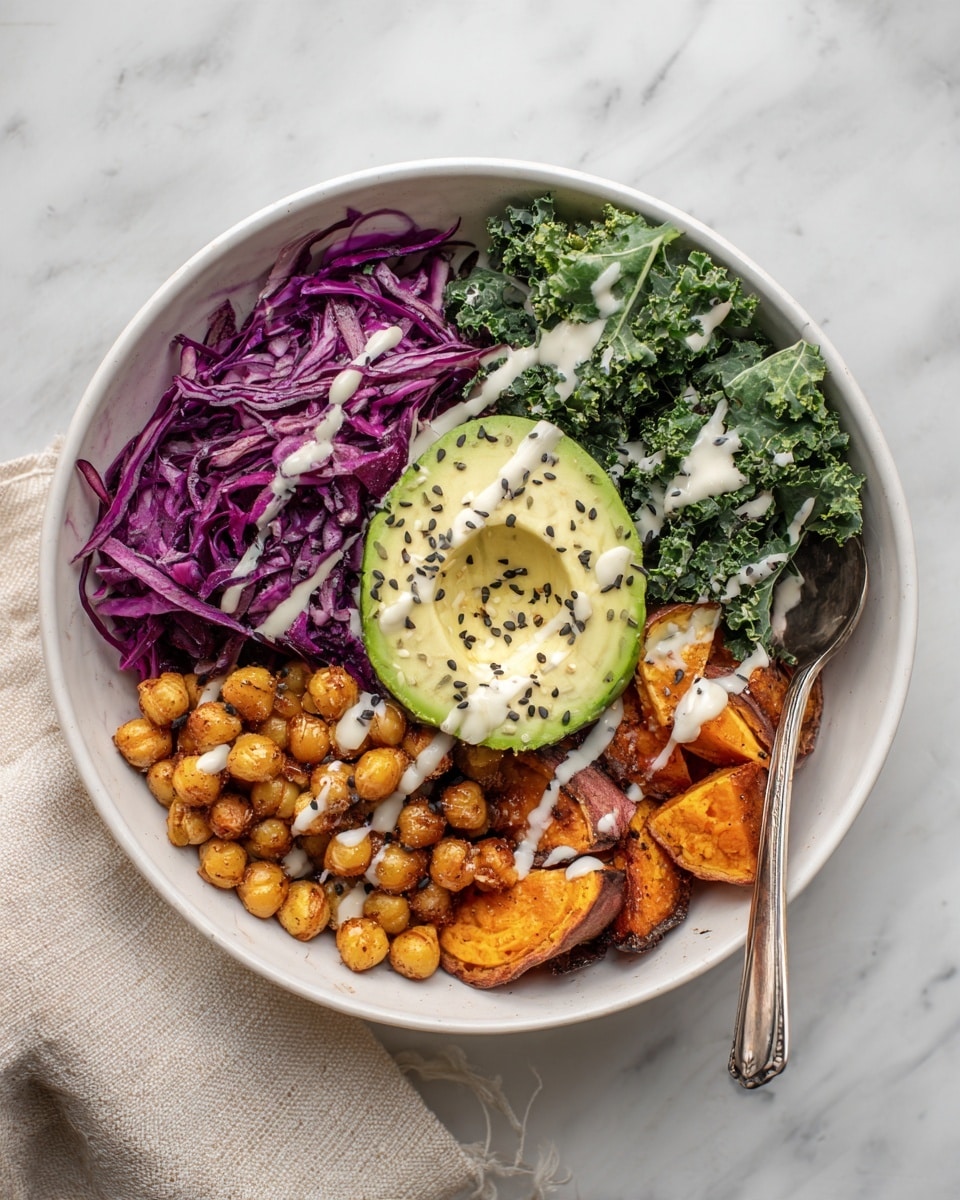 A white bowl on a white marbled surface contains five visible layers of food arranged side by side. Starting from the top left, there is a portion of purple shredded cabbage with a light drizzle of white sauce. Next to it on the right, there are roasted chickpeas, golden brown in color, also topped with white sauce. To the right of the chickpeas, there is a bunch of fresh green leafy kale with some white sauce drizzled on it as well. Below the kale, there are pieces of roasted orange sweet potatoes. In the center of the bowl, placed on top of all the other items, is a sliced half avocado sprinkled with black sesame seeds and a drizzle of white sauce. A small silver spoon stands inside the bowl near the kale. A beige cloth is partly visible at the bottom right corner. Photo taken with an iphone --ar 4:5 --v 7