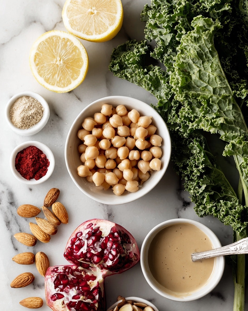 The image shows several fresh food ingredients on a white marbled surface. There is a bunch of green kale leaves on the right side, showing their curly texture and bright green color. Near the center, a white bowl is filled with round, beige chickpeas. Below it, a halved pomegranate reveals deep red seeds, some scattered around. To the left, two lemon halves with a bright yellow color are placed next to a small white bowl with three spices—light beige powder, red powder, and small red flakes. Below the lemon, a small white bowl holds sliced, light brown almonds. At the bottom right, a white bowl contains a light brown creamy sauce with a spoon resting inside. The scene is well lit, capturing the natural colors and textures of all the ingredients, photo taken with an iphone --ar 4:5 --v 7