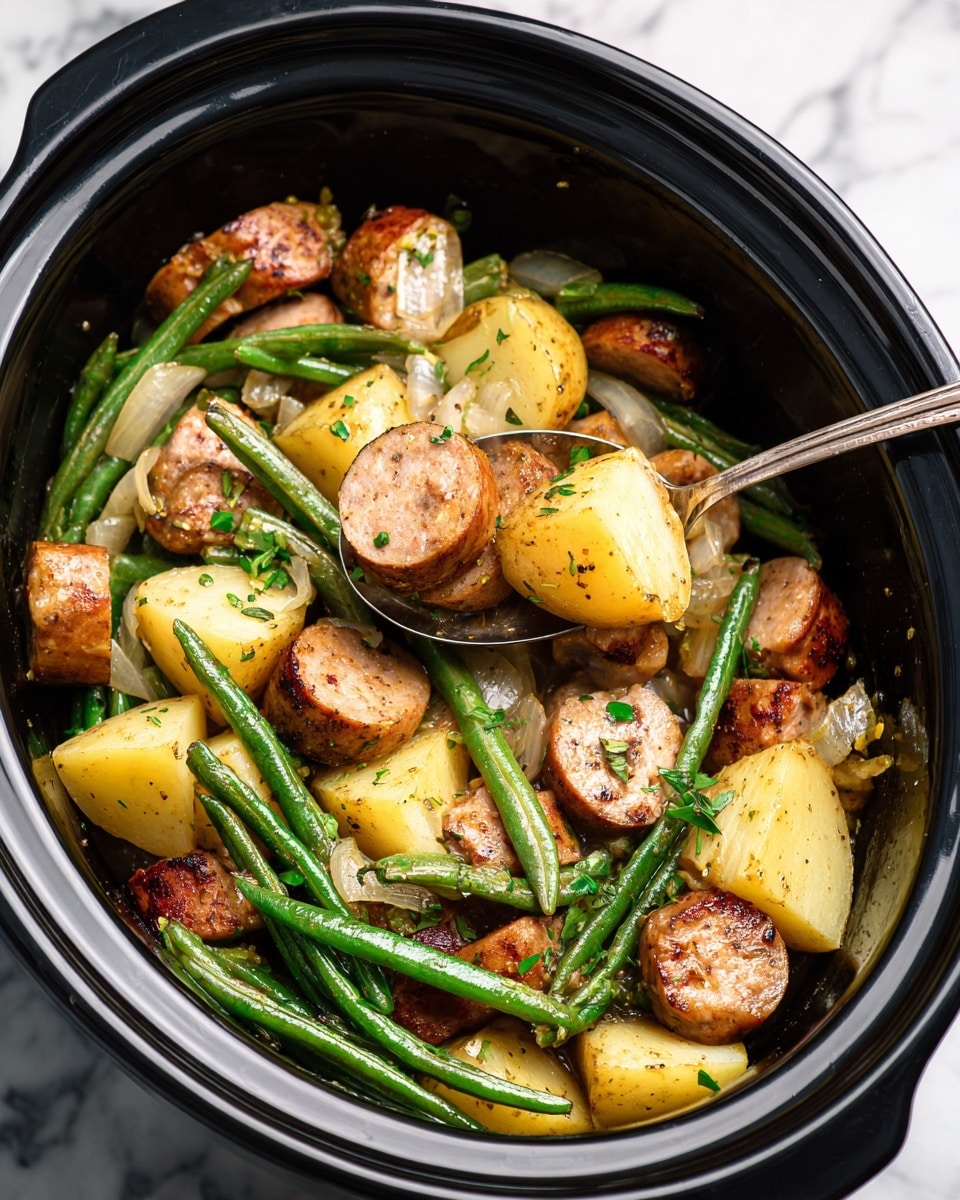 This image shows a black slow cooker filled with a cooked dish of sliced brown sausages, green beans, and large chunks of light yellow potatoes. The sausages are browned and mixed throughout, with some pieces partially hidden beneath the vegetables. The green beans are whole and scattered across the top and throughout the dish, their green color contrasting with the golden potatoes and browned sausage. Small pieces of cooked onion and fresh chopped green herbs are mixed in and sprinkled over the ingredients, adding texture and color. A silver spoon is scooping a portion that includes a sausage slice, green beans, and a potato chunk, hovering above the mixture. The background is a white marbled surface. Photo taken with an iphone --ar 4:5 --v 7