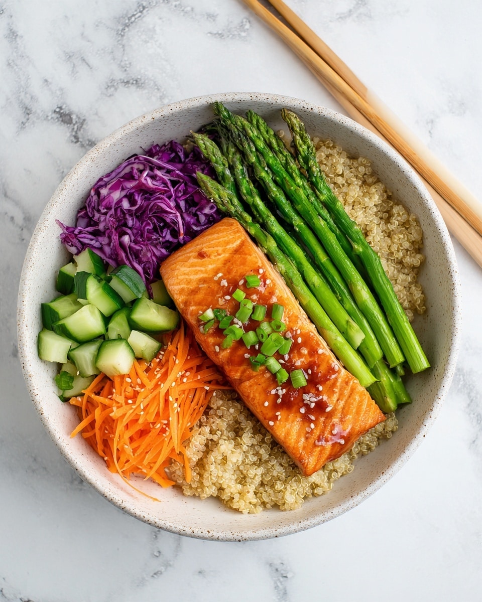 The image shows a speckled white bowl filled with a colorful salmon bowl. At the base, there is a layer of light brown quinoa covering the bottom. On top of the quinoa, a glazed, golden-brown cooked salmon fillet is placed in the center, garnished with small chopped green onions. On the right side of the salmon, a bunch of bright green asparagus spears are neatly arranged. Above the asparagus and partially under the salmon, there are thin orange shredded carrots. To the left of the salmon and carrots, chopped dark green cucumber pieces are placed. In the bottom left corner, there is a small section of shredded purple cabbage. The bowl is set on a white marbled surface with a pair of light wood chopsticks resting on the bowl’s rim. photo taken with an iphone --ar 4:5 --v 7
