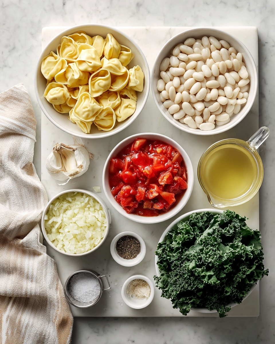 Top view of ingredients arranged neatly on a white marbled surface, including a white bowl of uncooked tortellini filled with cheese at the left, a white bowl filled with white beans above it, a white container of bright red diced tomatoes in the center, and a glass measuring cup of light yellow broth to the right. Below the beans and tortellini are a white bowl with finely chopped white onions, a smaller pile of minced garlic, and a white bowl with fresh dark green kale leaves. Small containers hold ground black pepper, other spices, and a small metal cup of salt, all placed near the bottom. A folded towel with beige and white stripes lies at the left edge, completing the fresh and organized setting. Photo taken with an iphone --ar 4:5 --v 7