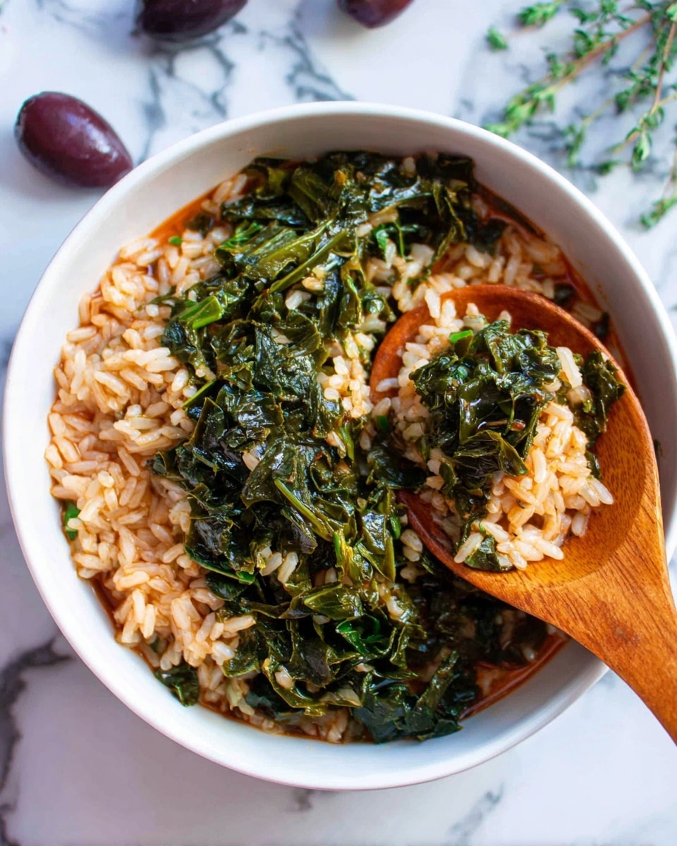 The image shows a white bowl filled with a mix of cooked rice and dark green leafy vegetables in a reddish broth. The rice is soft and spread all over the bowl in one even layer, blending with the greens that appear wilted and tender. A wooden spoon is partly dipped in the mixture on the right side, scooping some of the rice and greens. The bowl sits on a white marbled surface, with some blurred dark objects and purple olives visible in the background. The colors mainly include white, green, and reddish-brown. photo taken with an iphone --ar 4:5 --v 7