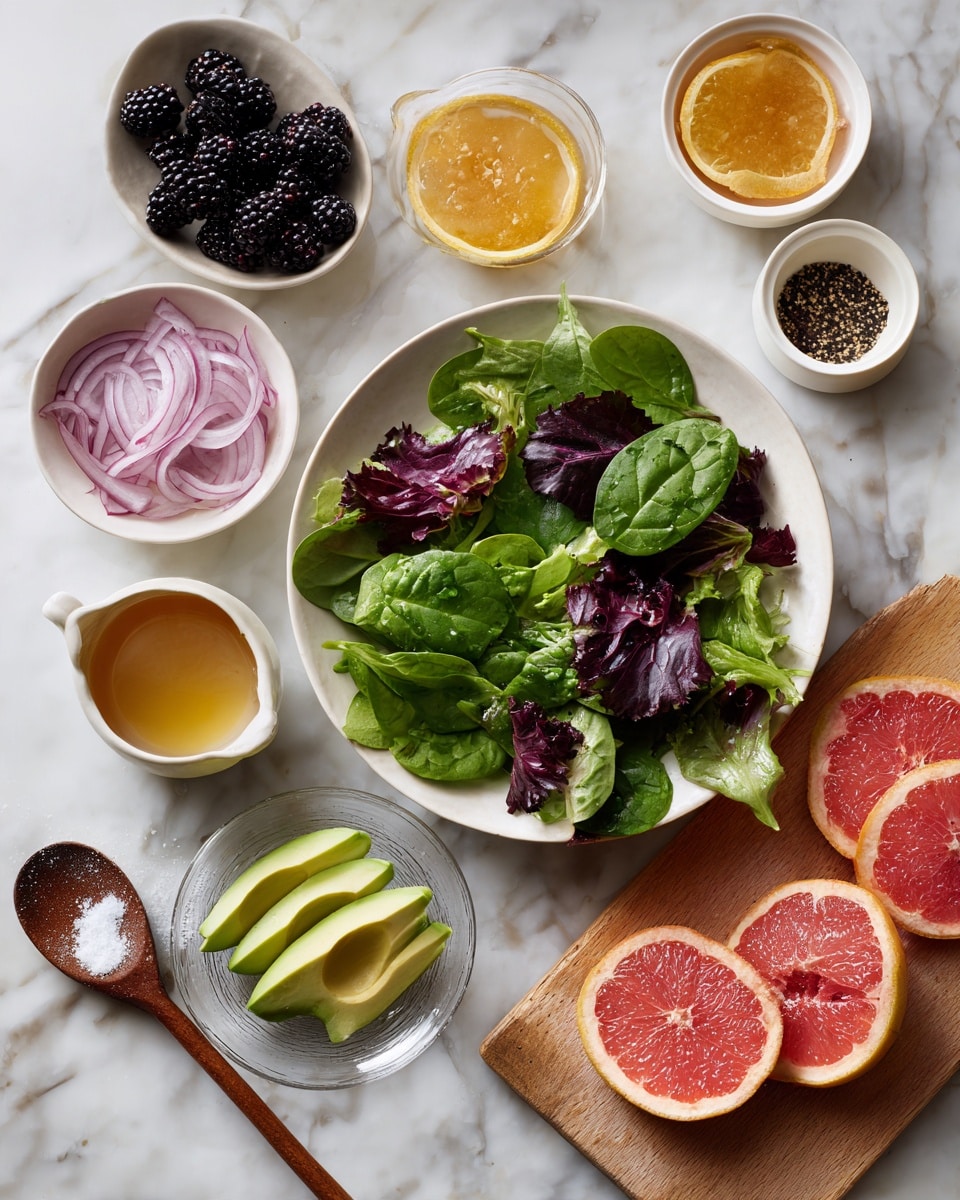 A top-down view of a fresh salad setup on a white marbled surface. In the center, there is a white bowl filled with mixed leafy greens including spinach and lettuce with different shades of green and red veins. Surrounding it, there are several small white bowls and dishes with various ingredients: thin slices of purple-red onions, blackberries, peeled yellow orange segments arranged in a circular pattern on a clear glass plate, and three slices of avocado with smooth pale green flesh in a white bowl. There is also a small cup with a golden liquid, another dish with a darker golden sauce, and a wooden spoon with coarse salt or spices resting near the bowl. A wooden cutting board holds several peeled pink grapefruit slices arranged in a neat circle on a clear glass plate. The overall look is fresh and colorful. Photo taken with an iphone --ar 4:5 --v 7